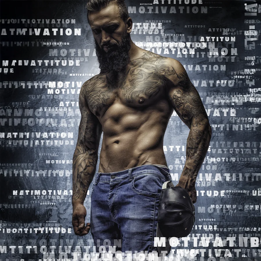 A ripped male fitness model, wearing blue jeans, strikes a pose on a backdrop filled with motivational words and aspirations, featured on the cover of a U.S. based national fitness magazine.